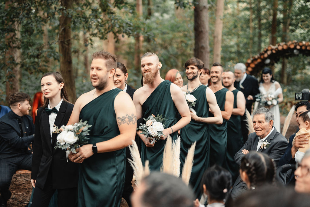 Bridesmaids in suits and groomsmen in Shein dresses at quirky wedding ceremony