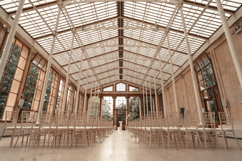 Sudanese wedding ceremony at Nash Conservatory in Kew Gardens with natural sunlight streaming through glass walls