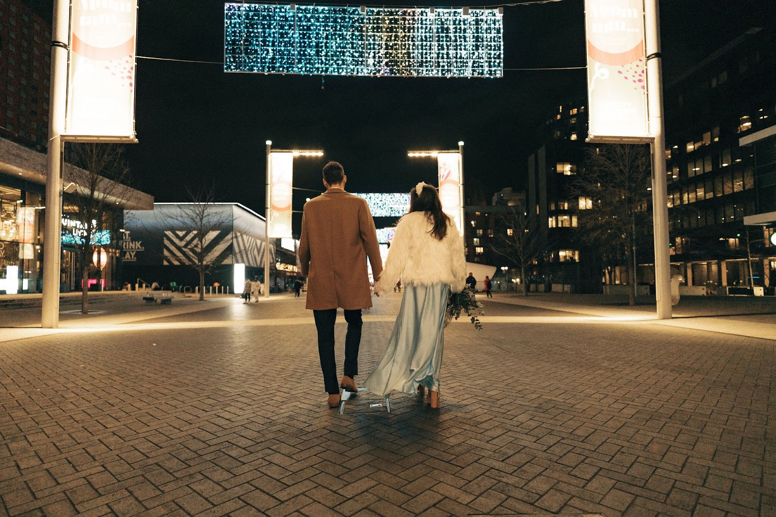 Bride and groom walking through the city