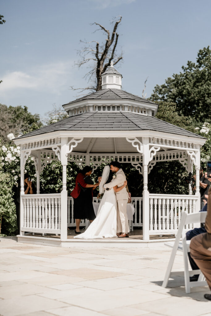 bride and groom embrace after marriage ceremony at morden park house 