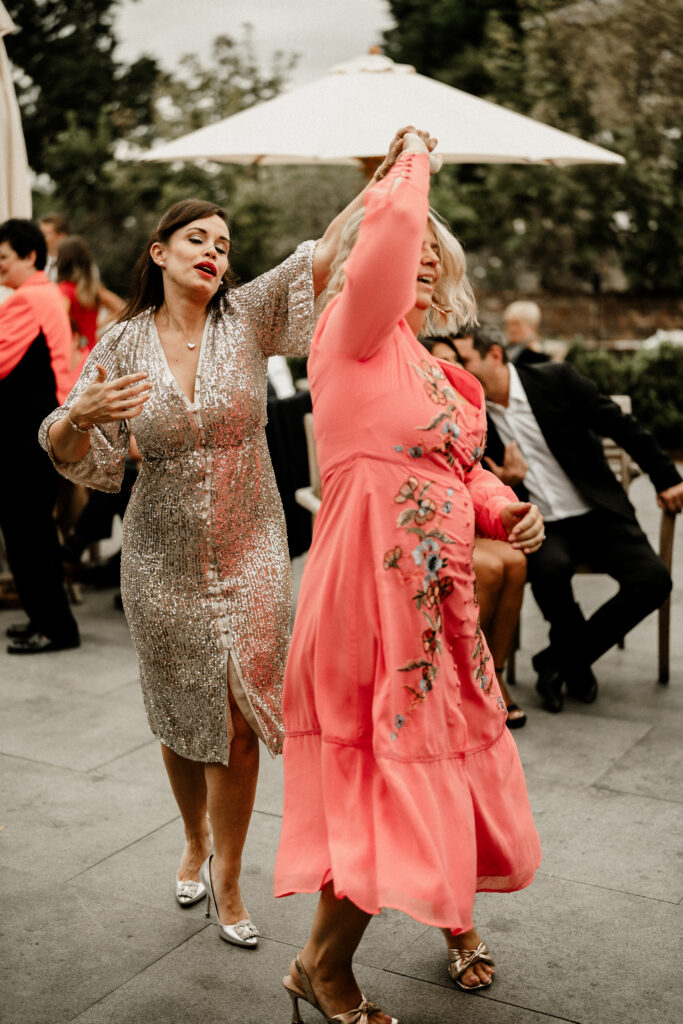 Guests enjoying live band outside during wedding drinks reception