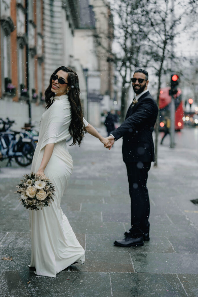 Snow falling during Chelsea Town Hall wedding photographs